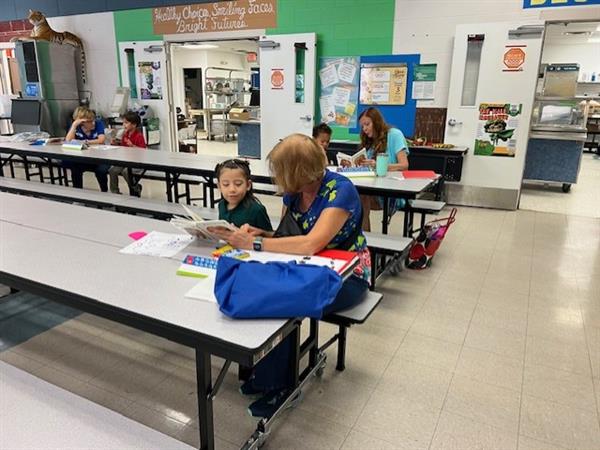 student with a reader